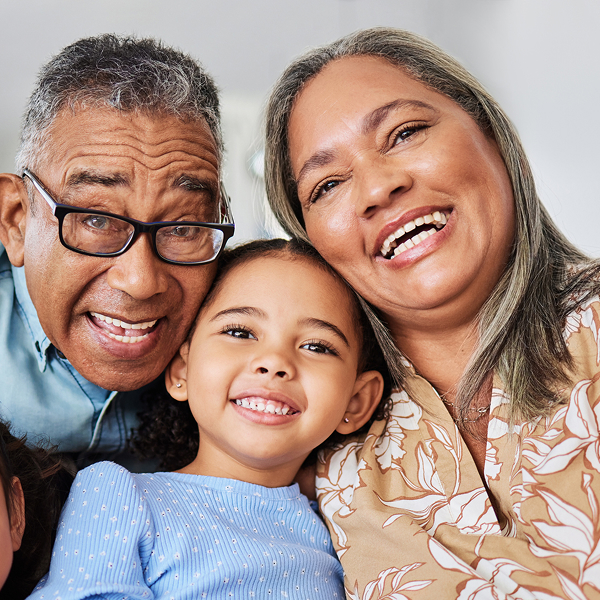 Parents and young child smiling