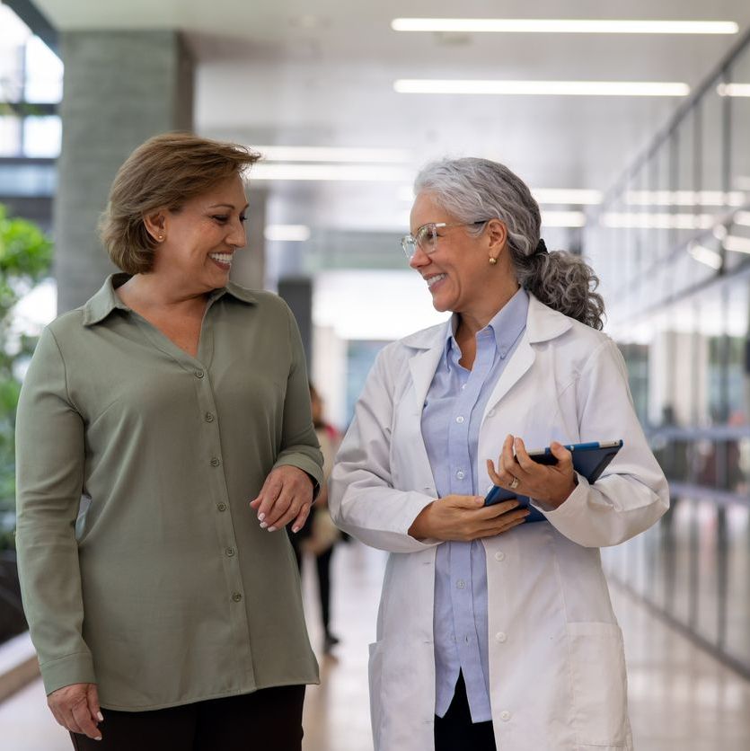 Happy doctor talking to a woman