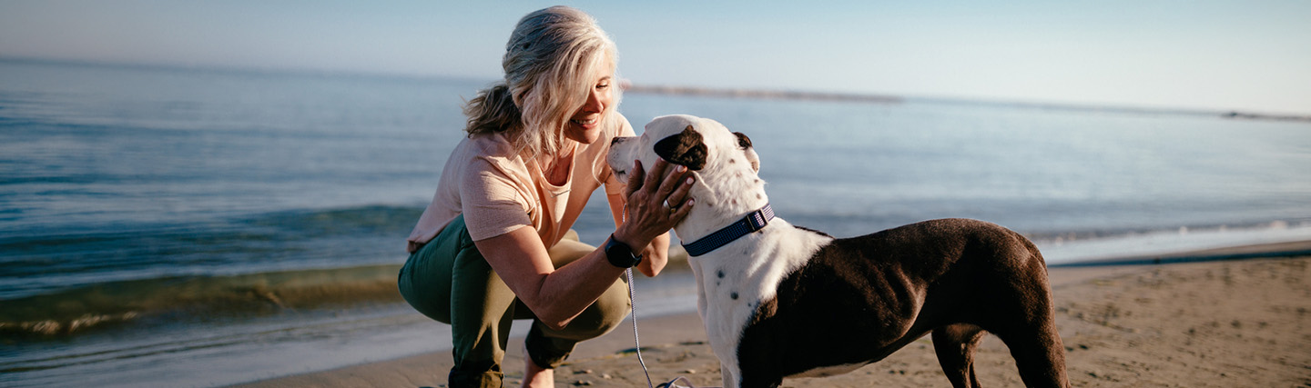 Woman with her dog at the beach